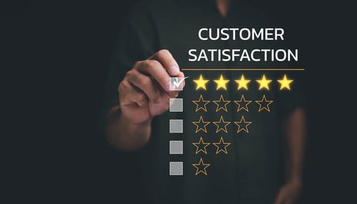 A person's hand selecting five stars in a customer satisfaction survey.