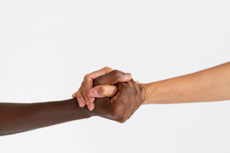 Close up of a white and brown hand shaking hands.