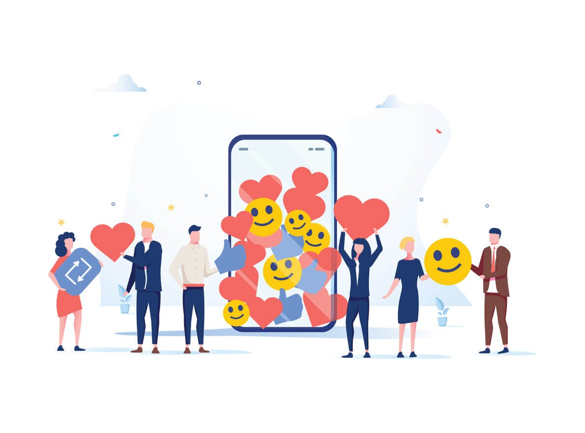 Group of people gathering around a large mobile device filled with smile emojis, hearts, and repost symbols.